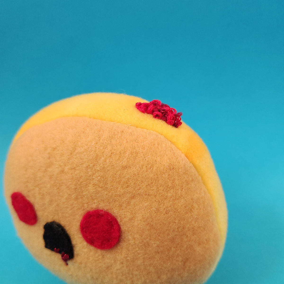 detail of plush toy of a zombie Undead Jelly Donut looking for jam brains by Taneko Says Hello