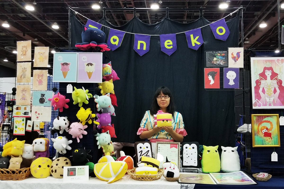 Taneko Says Hello table booth display at Youmacon