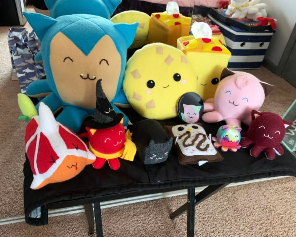 several handmade plush toys sitting on a table