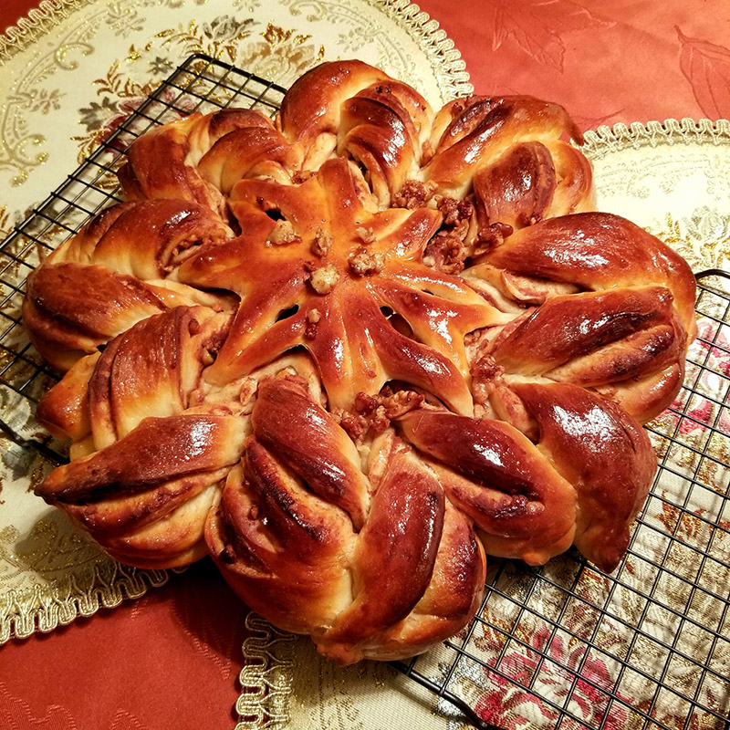 cinnamon star plaited bread on a red tablecloth