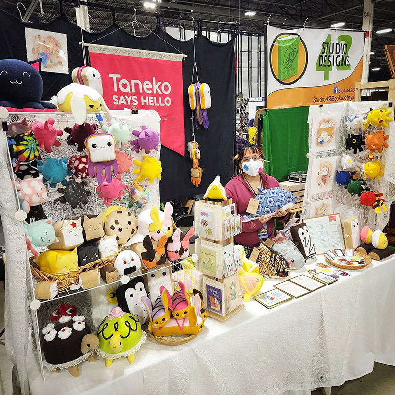 Taneko Says Hello table booth display at Motor City Comic Con