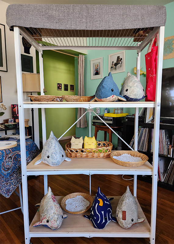 white bookshelf with plush toys