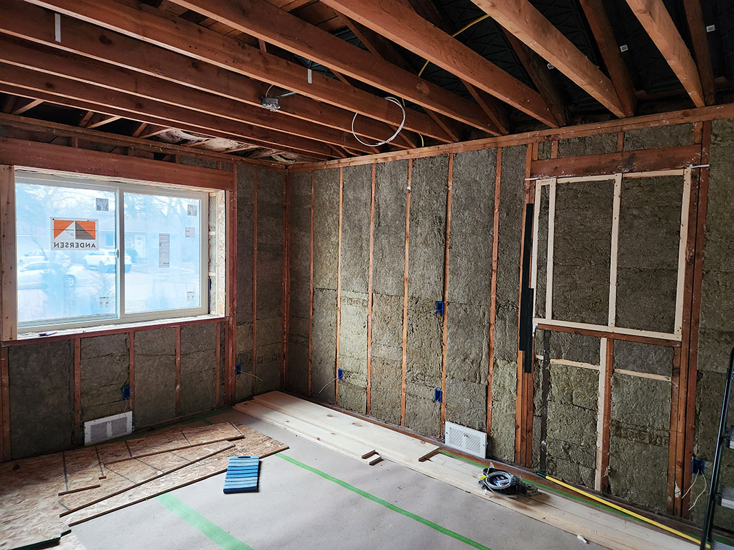 house framing with wall insulation installed