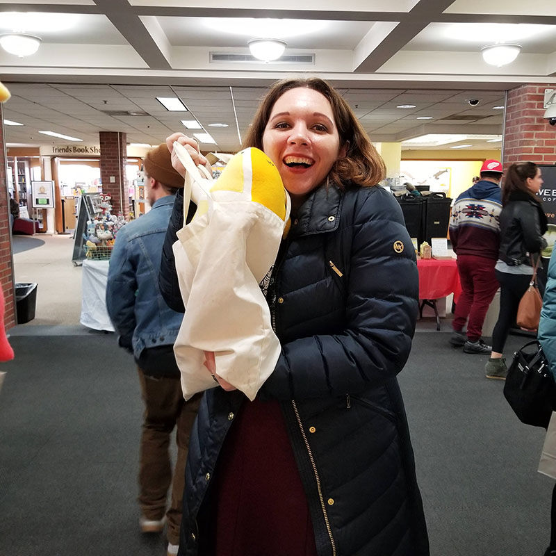 happy person with a Lemon Shark plush toy at Tiny Expo