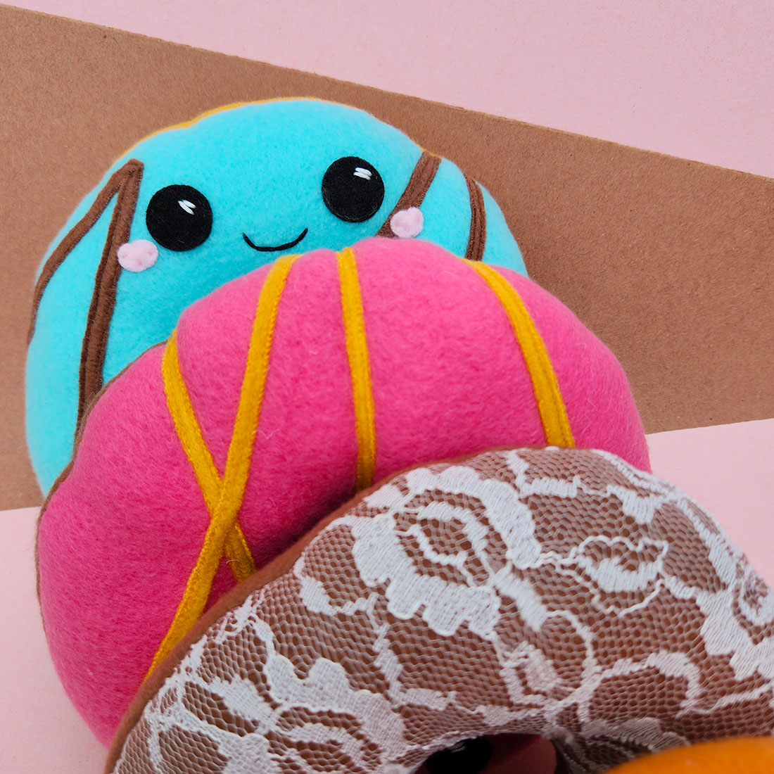 close up of handmade blue frosted donut plush toy // Substrate Coffee X Taneko Says Hello