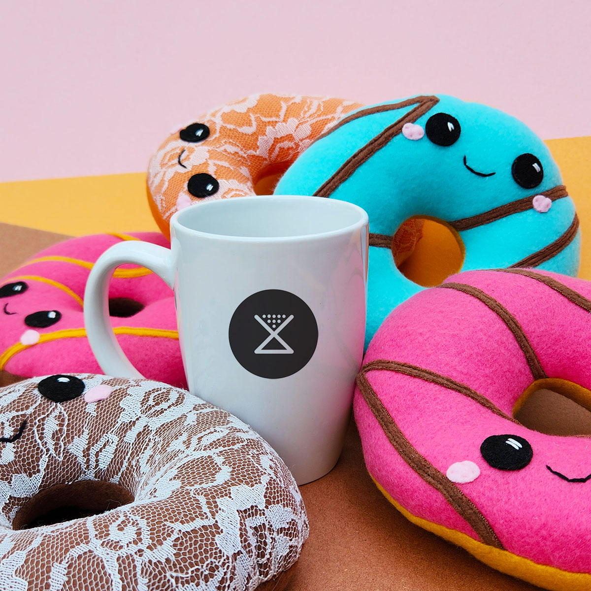 five handmade donut plush toys around a mug of Substrate Coffee // Substrate Coffee X Taneko Says Hello